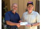 Galen Teichert presenting check to Glenn Rettmann.