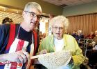 Jim Papke showing Rose Odegaard one of his samples of lefse.
