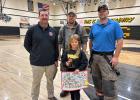 Donnie Prosser Overall Award Winner: 3rd Grader Luna Erickson pictured with firefighters Nick Rankin, Jake Hagen, and Bryce Torgerson.